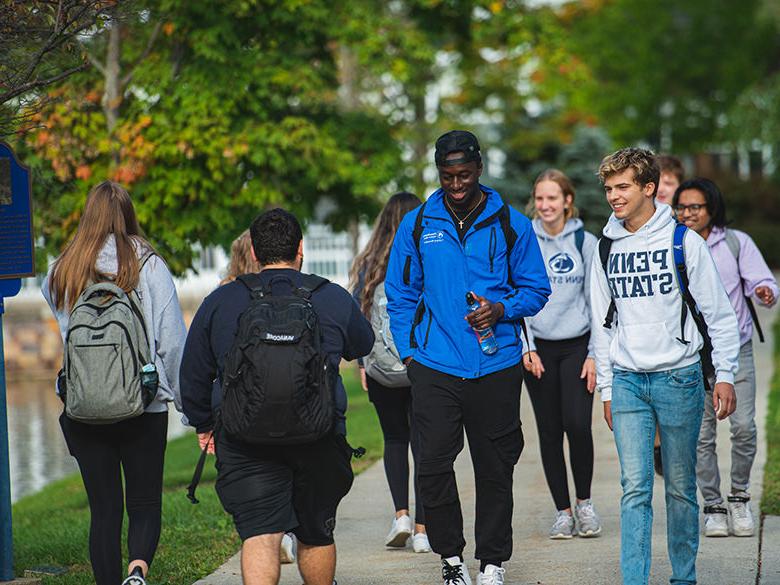 A diverse group of students walking on campus